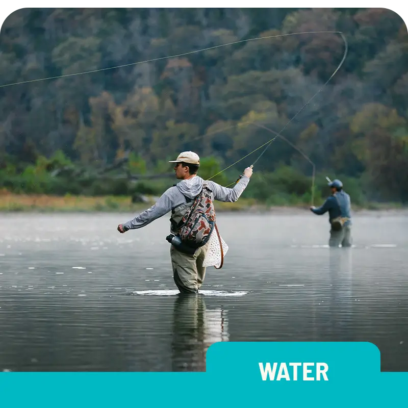 A person fly fishing in a calm river surrounded by trees, with the word "WATER" displayed in bold at the bottom.