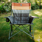 Front view of an olive Comfort Pro Insulated Rocker with striped insulated padding, set on a grass lawn.