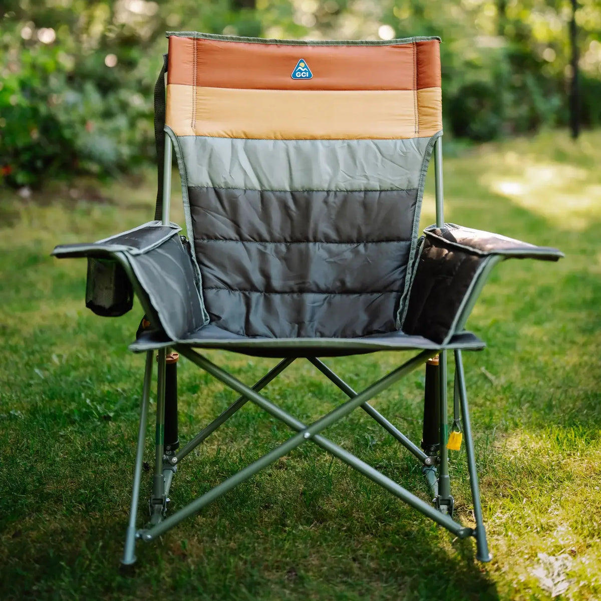 Front view of an olive Comfort Pro Insulated Rocker with striped insulated padding, set on a grass lawn.