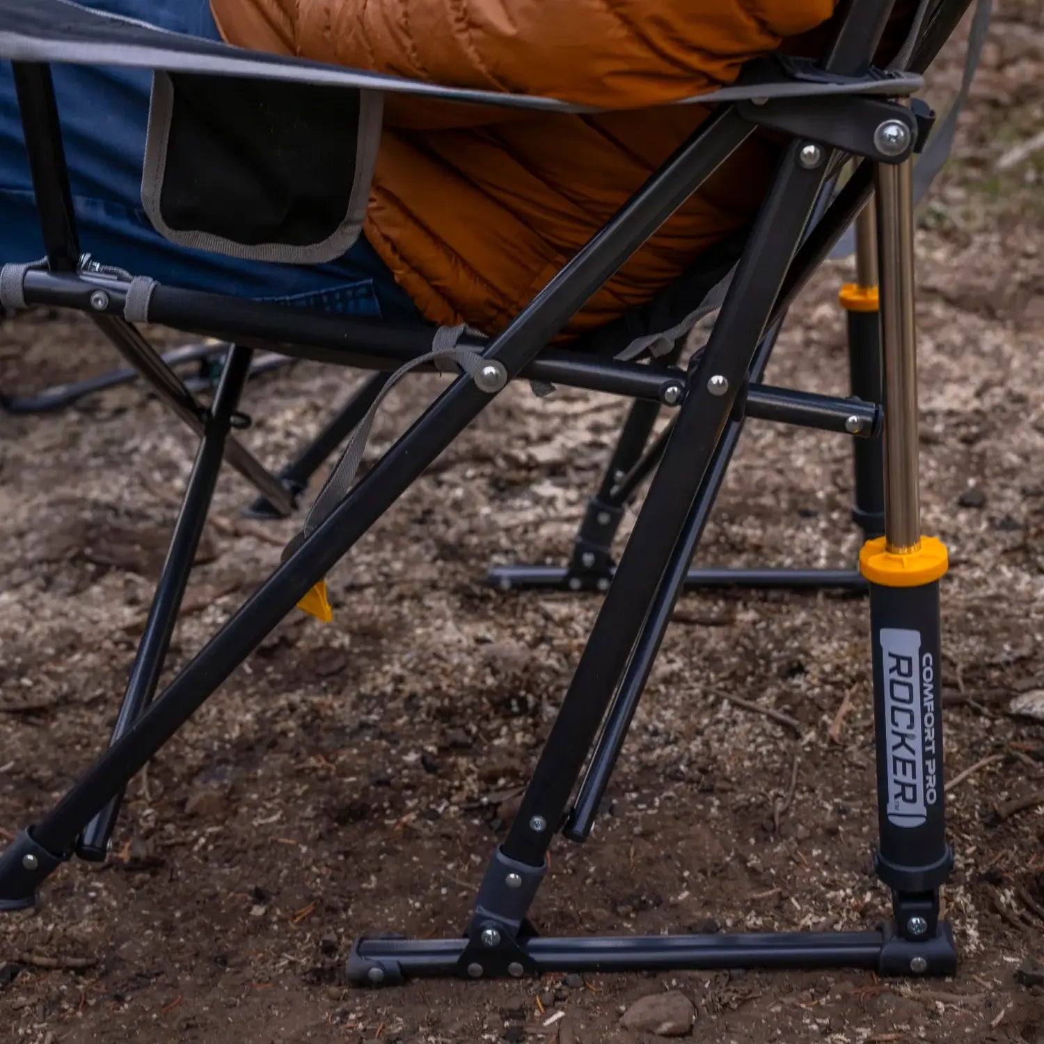 Close-up of the freestyle rocker's spring-action rocking system shocks in an outdoor setting.