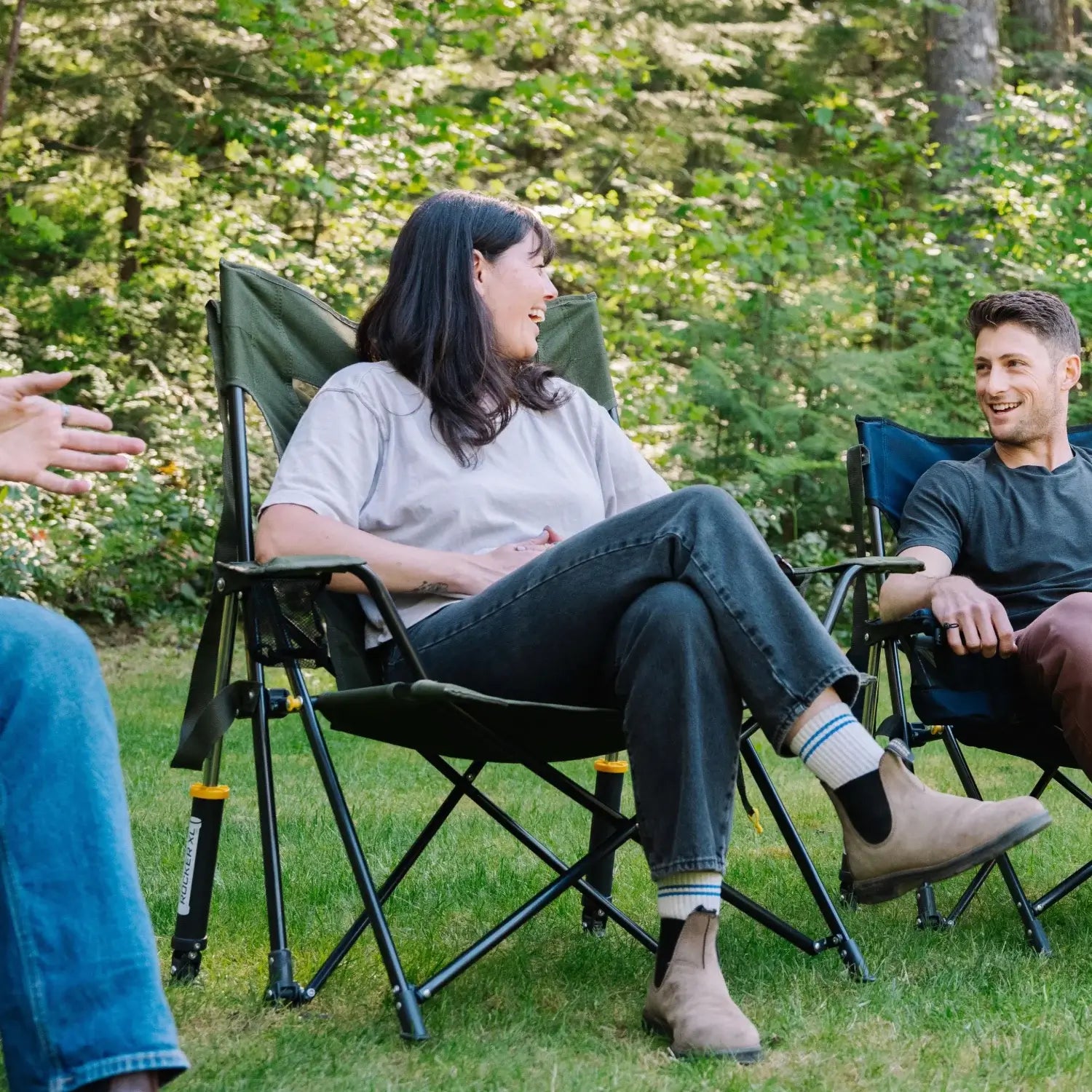 Woman laughs while seated in a heathered olive Comfort Pro Rocker XL alongside a man in a navy chair.