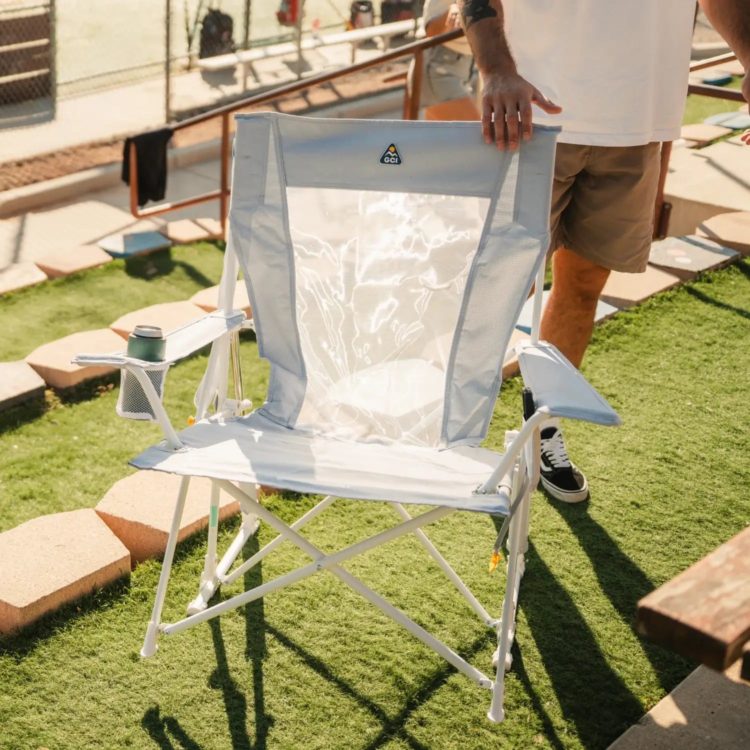 GCI Outdoor Comfort Pro Rocker XL in Heathered Light Blue, front angle view, near a softball field.