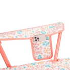 Up-close of the phone holder pocket on the Comfort Quad Chair in coral sundress print.
