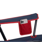 A phone inside the phone pocket of the indigo/red Comfort Quad Chair. 