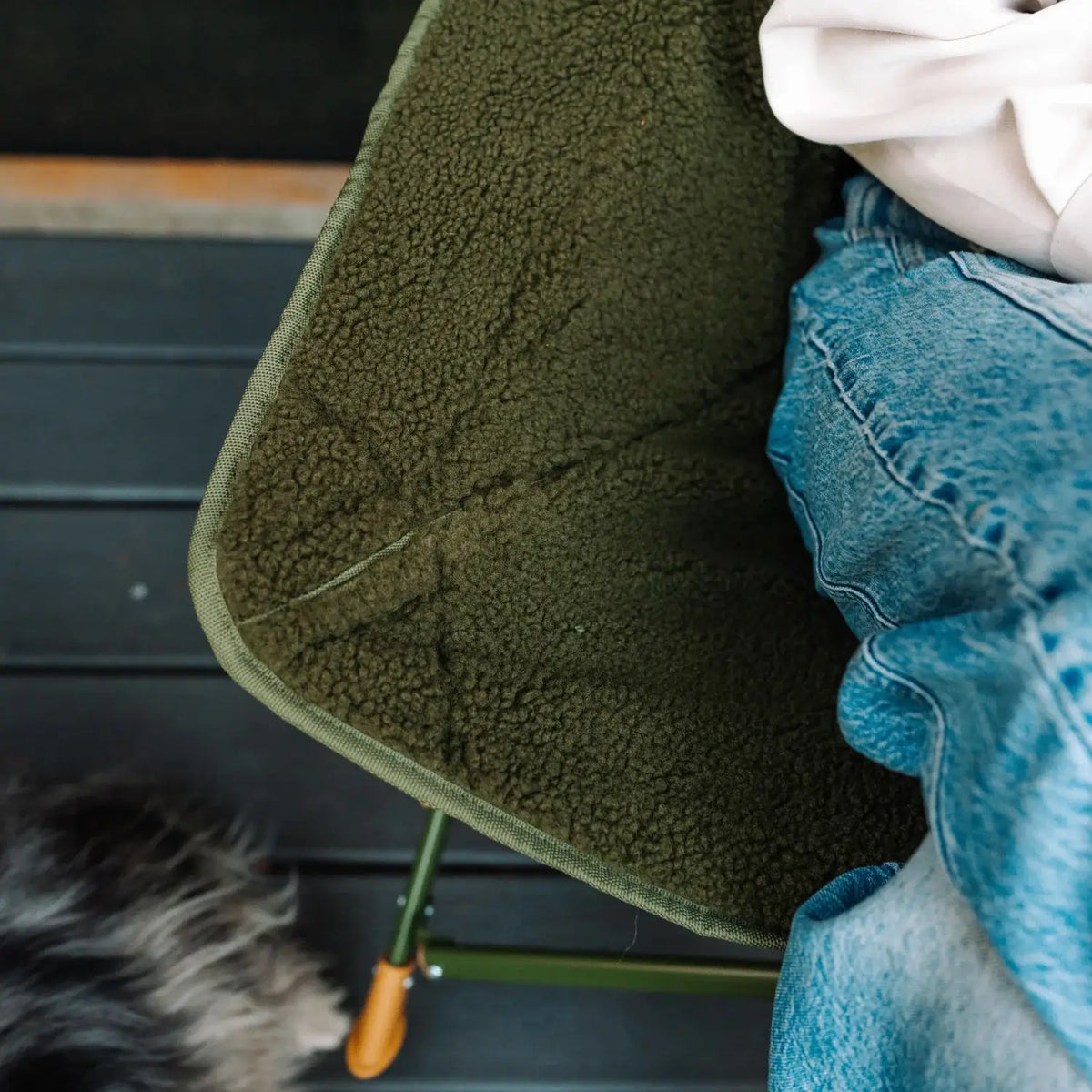 Close-up of the fleece-lined seat on an olive Fleece Rocker.