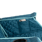 Close up view of the phone holder pocket on the teal Kickback Insulated Rocker.