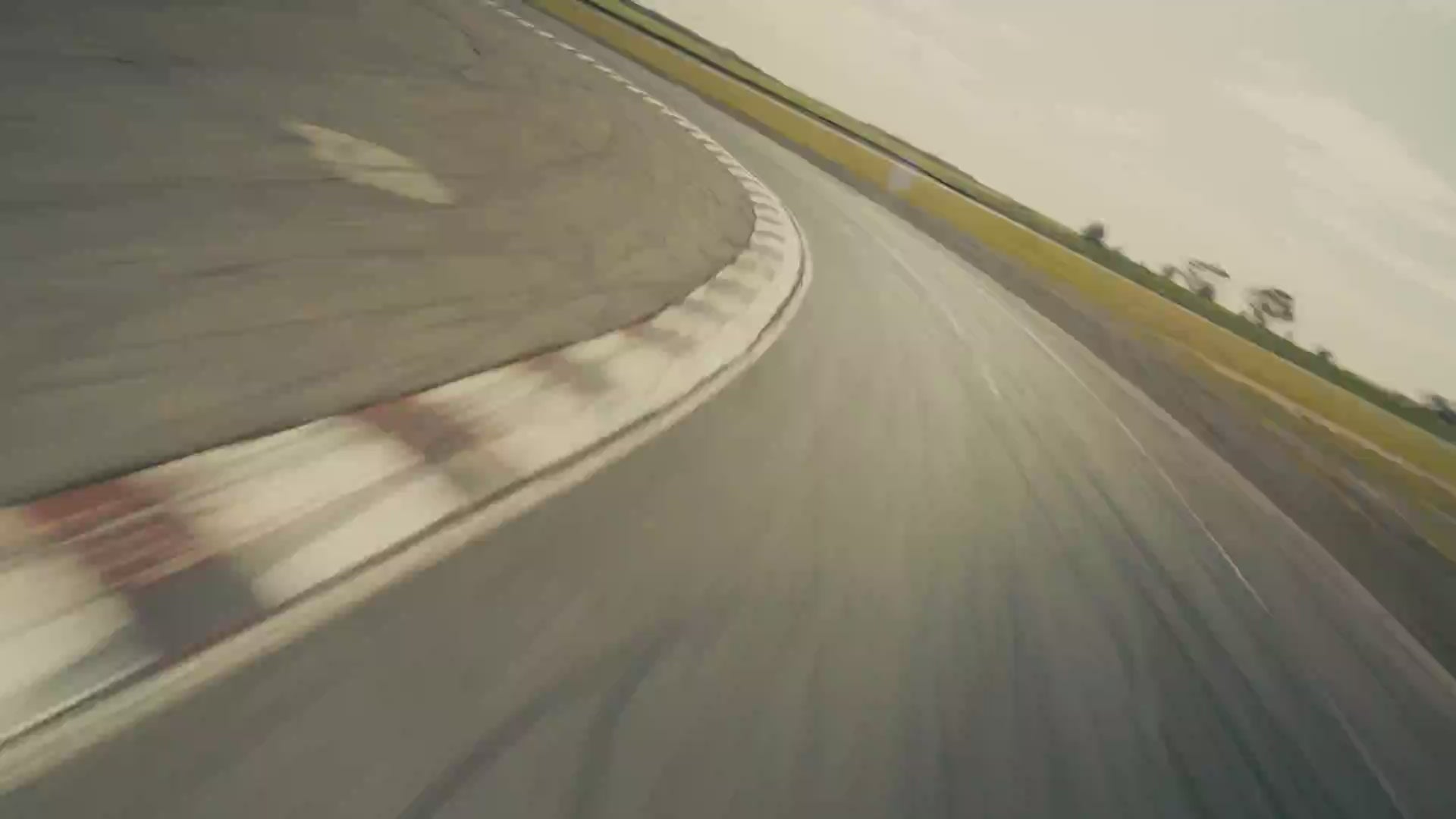 Multiple clips of a racetrack speedway with audience members and cars. 