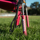 Close-up of the rocking legs on a pink flame waves Stowaway Rocker, set on a grass field.