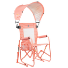 Front right angle of the coral Sunshade Accessory attached to a coral Stowaway Rocker. 