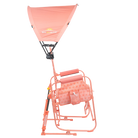 Side angle of the coral Sunshade Accessory attached to a Coral Stowaway Rocker. 