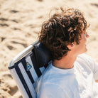 Padded headrest on TidalDrift indigo stripe backpack beach chair for comfortable lounging.